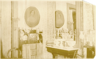 Corner view of elaborate room with mirror, bookshelf, and portrait of same woman in #78