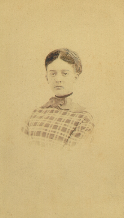 Lizzie Lyle wearing plaid dress as a young woman