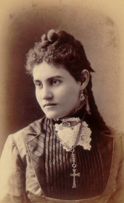 Young woman wearing black dress and cross necklace; Western Female Seminary