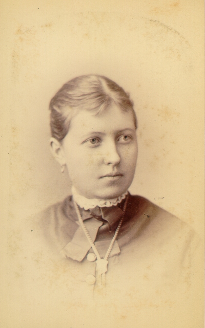 Young woman wearing dark dress and pearl necklace,; Western Female Seminary