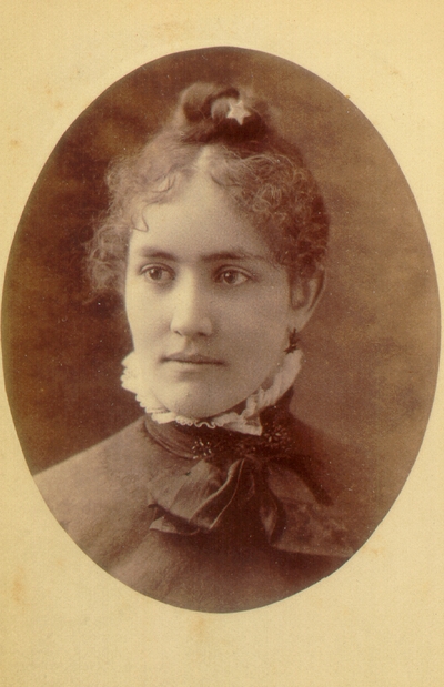 Young woman wearing dark dress and small star pin in hair; Western Female Seminary