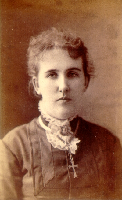 Young woman wearing dark dress and cross necklace; Western Female Seminary