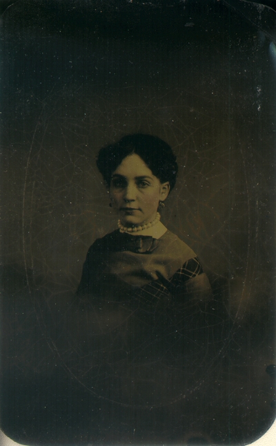 Woman wearing dress and large pearl necklace