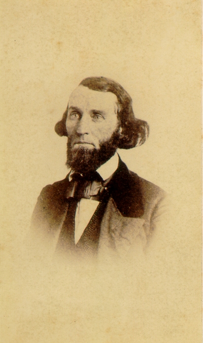 Man with full beard and long hair wearing suit