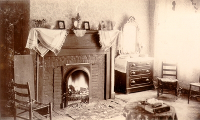 Parlor with fireplace, dresser, and several chairs