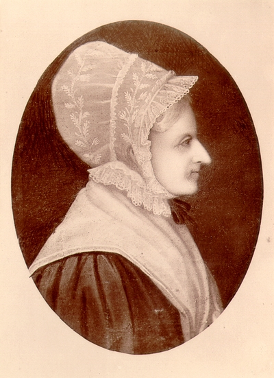 Profile view of elderly woman wearing bonnet