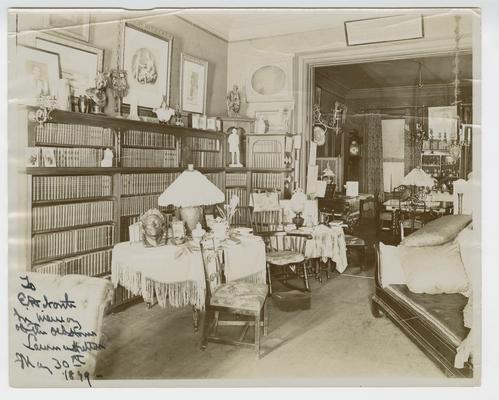 Laurence Hutton note on a photograph of a parlor with bookshelves to Ernest Dressel North