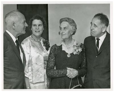 Group of four men and women, (l to r) Dr. George Beadle (1903-1989), Mrs. Isabelle Morgan Mountain (?-?), Dr. Tove Mohr (?-?), and Dr. John W. Oswald (1917-1995), handwritten on back                              Dr. George Beadle U of Chic + a Nobel Prize winner / Mrs. Isabelle Morgan Mountain - Mt. Kisco, NY daughter of / Dr. TH Morgan / Dr. Tove Mohr - Oslo, Norway / Dr. John W. Oswald UK President, photo is stamped                              Lexington Herald-Leader Staff Photo