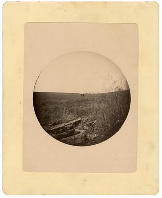 Two unidentified men standing in a field; removed from pg. 6 of album