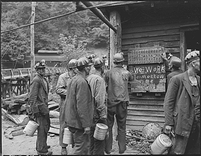 Miners bring in their checks and see the sign that there is no Saturday work.  Lejunior, Harlan County, KY. 9/13/46