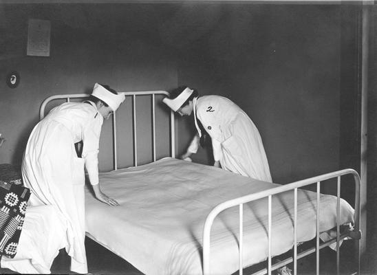 Women students making a bed