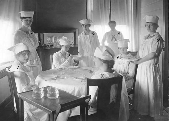 Women students at a table in the Home Economics Practice House?, duplicate