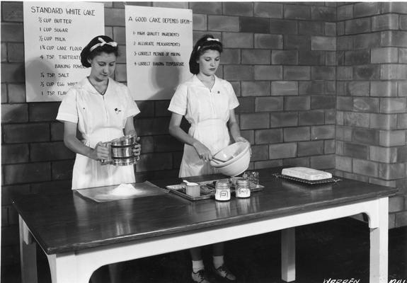 Students baking a standard white cake