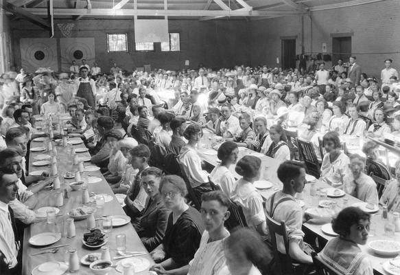 Large group of men and women preparing to eat