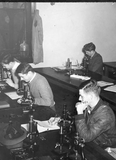 Joe Beard, Students looking in microscopes