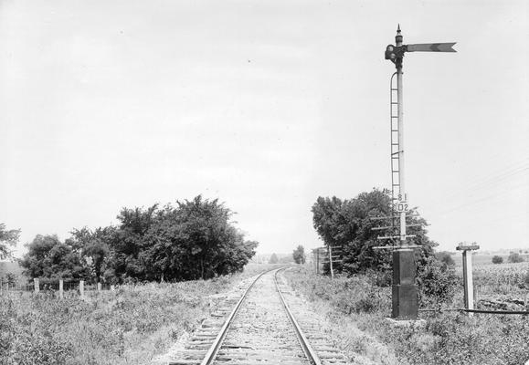 Railroad tracks and signal with 81/02 marker