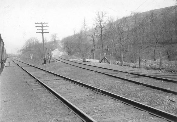 Railroad tracks train, near hill