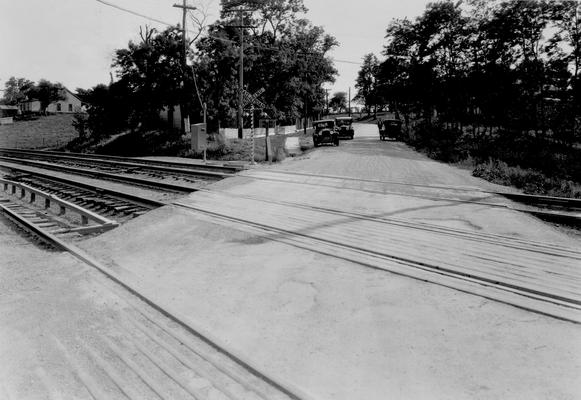 Automobiles near railroad tracks