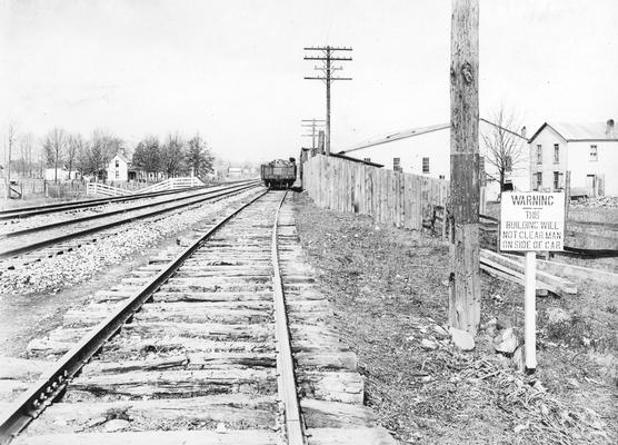 Tracks with railroad car and warning sign