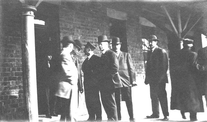 Group of men standing at station