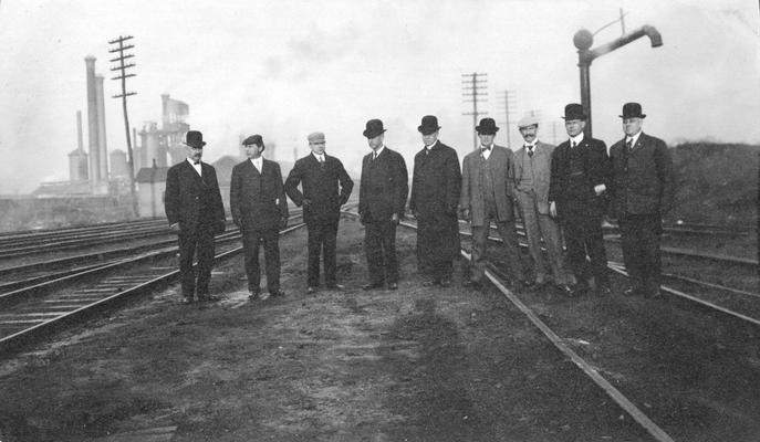 Group of men standing near tracks