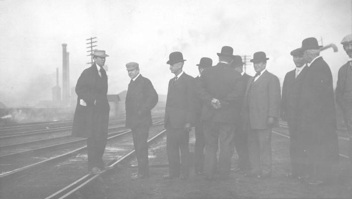 Group of men standing on tracks