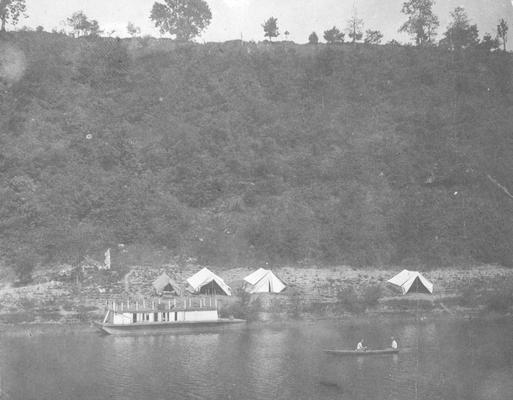 Encampment of Mill, tents near river and men in canoe