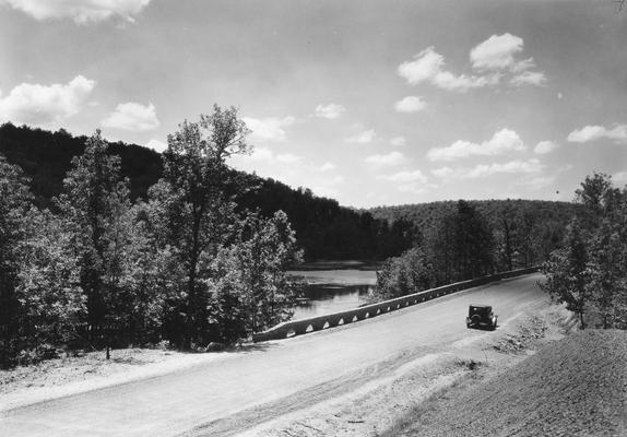 Bridge over body of water with car