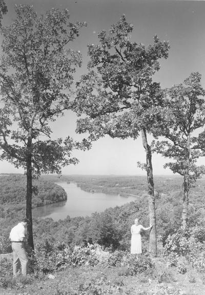 Site of Northern Center?, man photographing woman by tree overlooking river