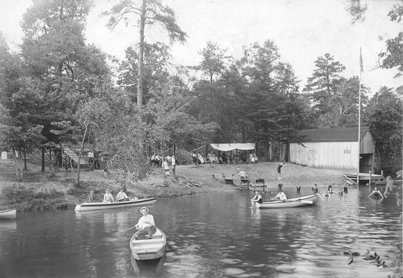 People swimming and in boats