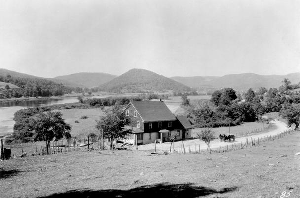 Farm house with horses and wagon