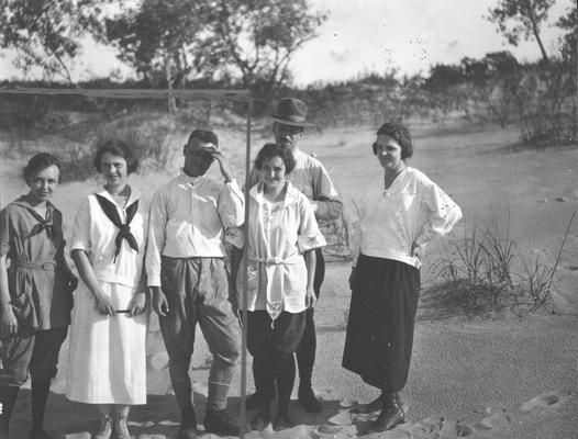 Group of people standing in sand