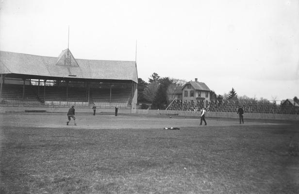 Men playing baseball at unidentified stadium