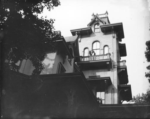 People standing on balcony of house