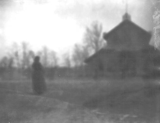 Faded image of person looking at building