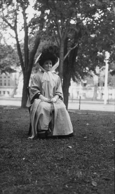 Unidentified woman, dressed in duster and hat tied for travel