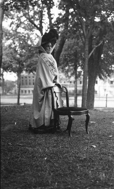 Unidentified woman, dressed in travel duster and hat