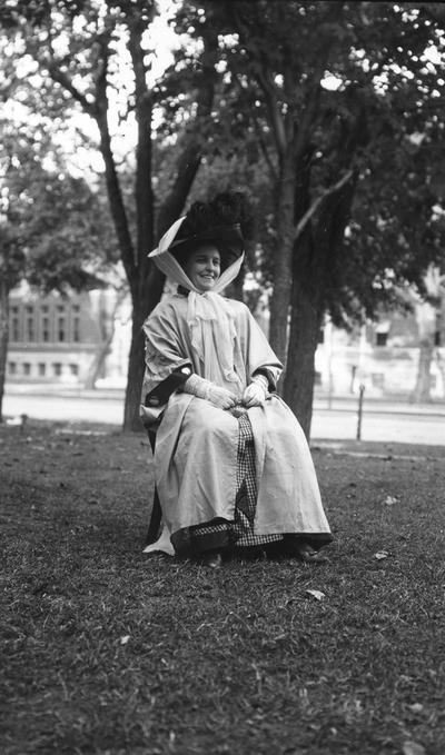 Unidentified woman, dressed in travel duster and hat