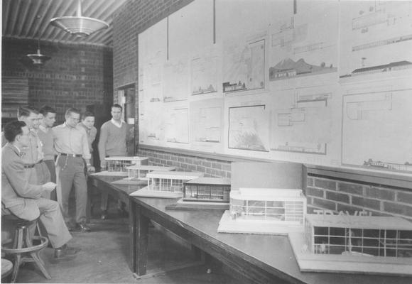 Men looking at blueprints and models