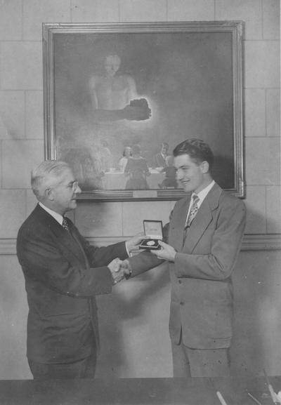 W.E. Freeman, Engineering, presenting a young man an award