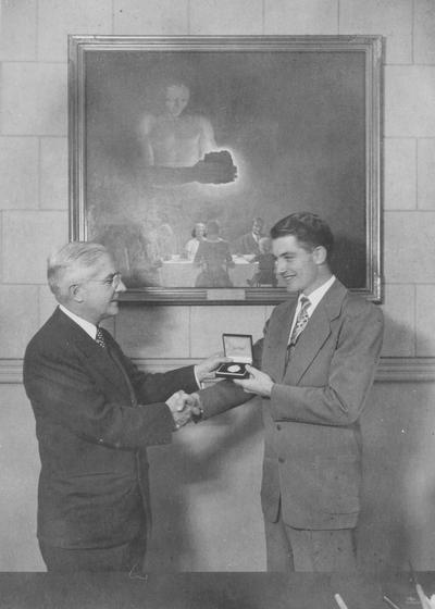 W.E. Freeman, Engineering, presenting a young man an award, duplicate