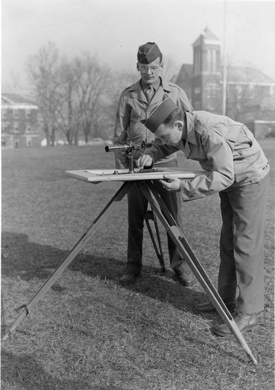 Two men in military uniform surveying