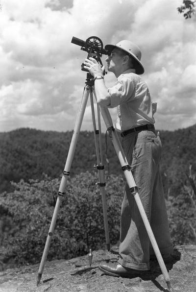 Professor Louis Edward Nollau surveying on the field trip