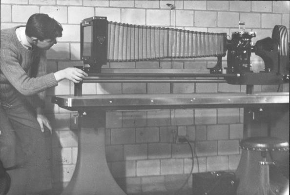 Bill Bruckart adjusts micrograph, 1941