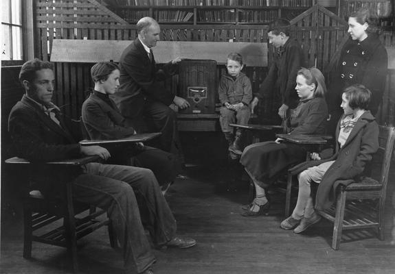 Students and teacher observing a radio