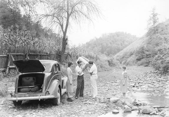 Persons and a car in rural area