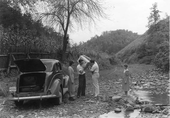 Persons and a car in rural area
