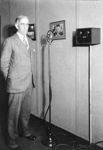 Frank L. McVey with microphone, at WBKY, forerunner of campus radio station, WUKY