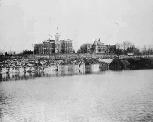 Barker Hall and the Administration Building in view across a lake, circa 1897 - 1903