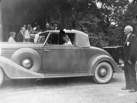 Maxwell Place visitors, Eleanor Roosevelt, spouse of the President of the United States of America, Franklin Roosevelt in her car. She had spoken in the chapel assembly, July 7, 1934. By the car is Mr. Jewell, Mrs. Frances Jewell McVey's father